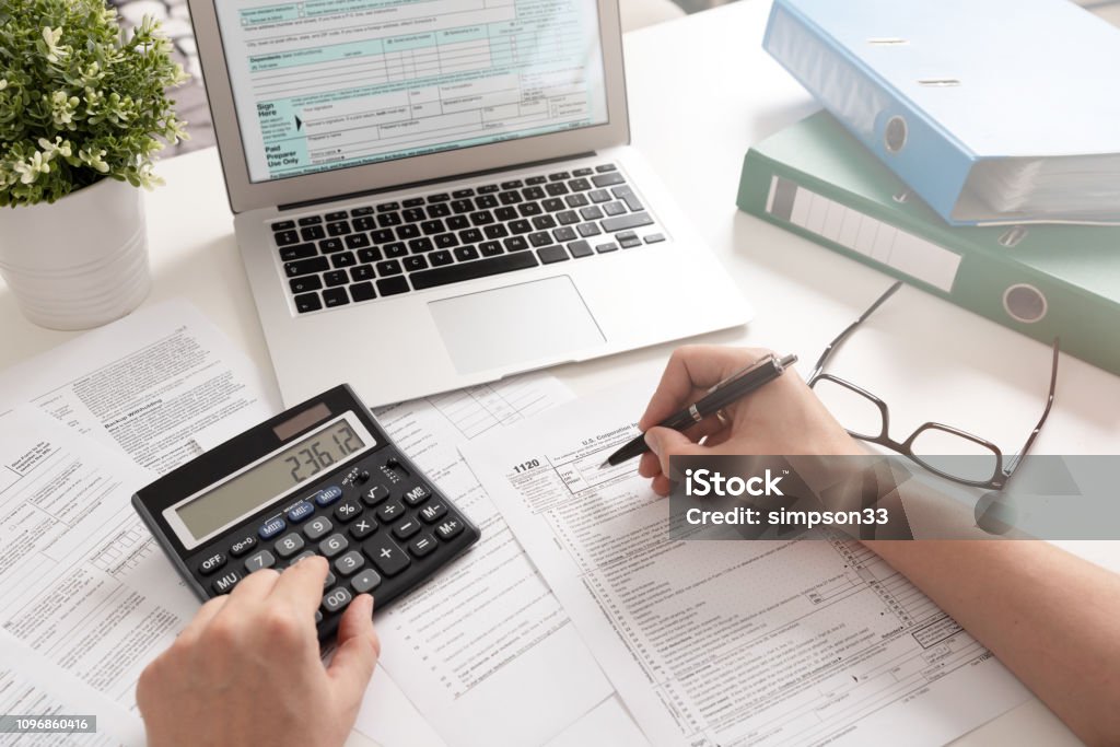 Accountant working with US tax forms US Individual income tax return. Accountant working with US tax forms Tax Stock Photo