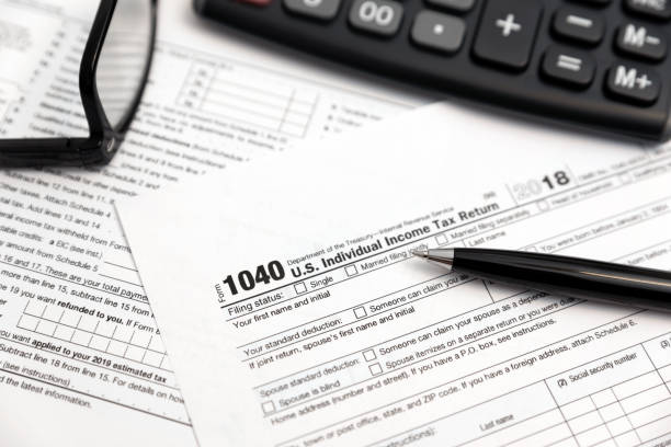 U.S. Individual income tax return U.S. Individual income tax return. Tax form 1040 with eyeglasses and pen 2018 stock pictures, royalty-free photos & images