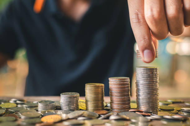 istock Save money concept with hand putting the coin on coin stack growing business 1096861638