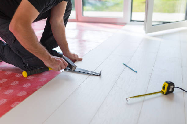 istock Handyman installing new laminated wooden floor 1096861822