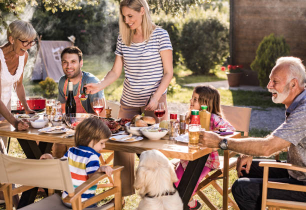 istock Happy extended family enjoying while having their lunch in the front yard. 1096862572