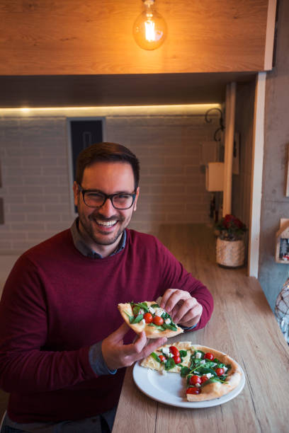 istock Man is pleased with pizza 1096864878