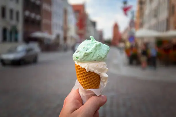 Mint ice cream with the cone in hand