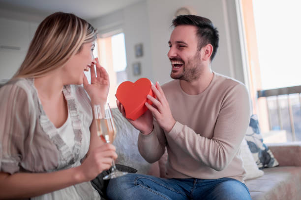 istock Young romantic couple sitting on sofa in living room 1096872542