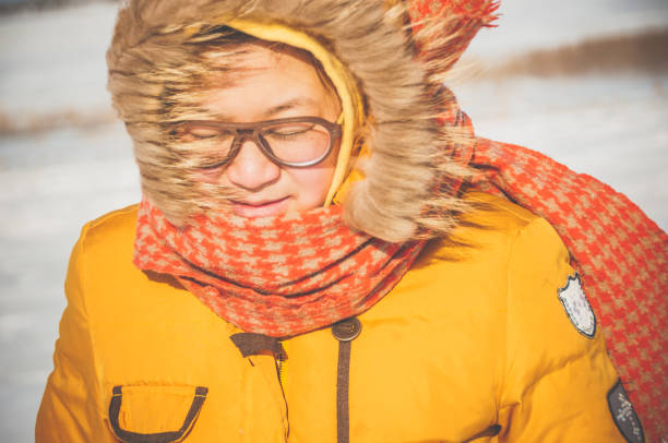 A Chinese woman walking on the snow ground in the winter.