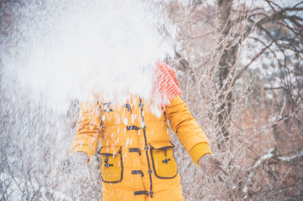 A Chinese woman walking on the snow ground in the winter.