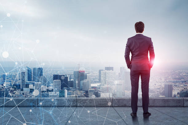 istock Businessman looking at city, network 1096877624