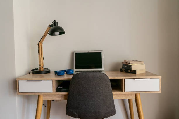 istock Home office desk with laptop and books 1096877636