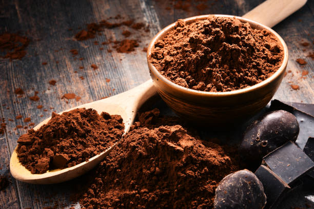 istock Composition with bowl of cocoa powder on wooden table 1096888206