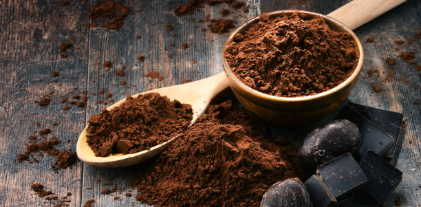 istock Composition with bowl of cocoa powder on wooden table 1096889150