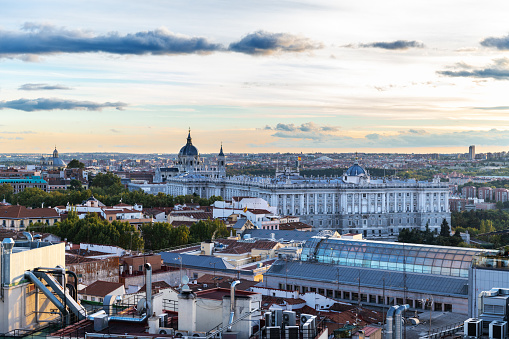 Aerial view of Madrid's skyline at dusk, with the Royal Palace and the Almudena Cathedral to be recognised in the background.
