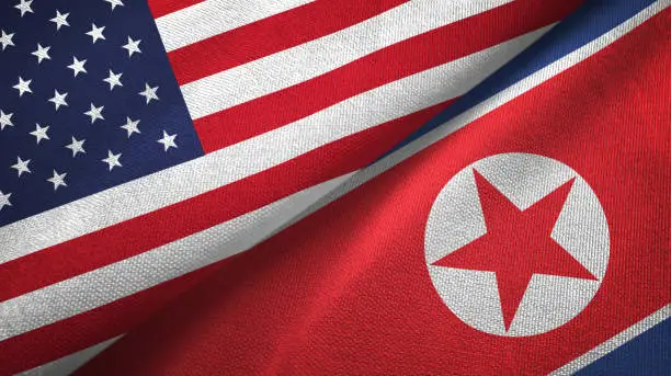 North Korea and United States flags together textile cloth, fabric texture