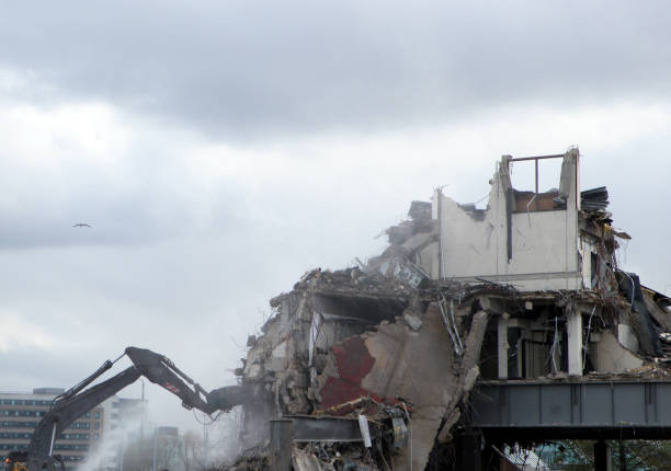 istock A digger working on a demolition site destroying a section of wall creating dust and rubble 1096901558