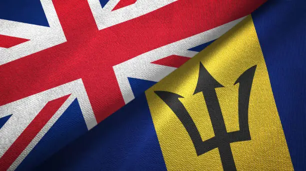 Photo of Barbados and United Kingdom two flags together textile cloth, fabric texture