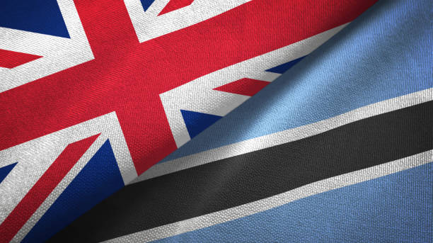 istock Botswana and United Kingdom two flags together textile cloth, fabric texture 1096903316