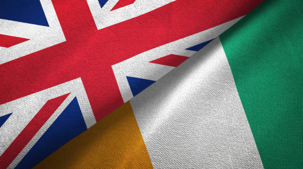 istock Cote d'Ivoire Ivory coast and United Kingdom two flags together textile cloth, fabric texture 1096904452