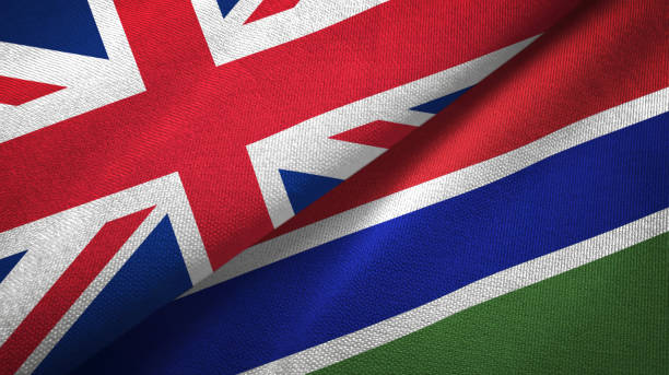 istock Gambia and United Kingdom two flags together textile cloth, fabric texture 1096904770
