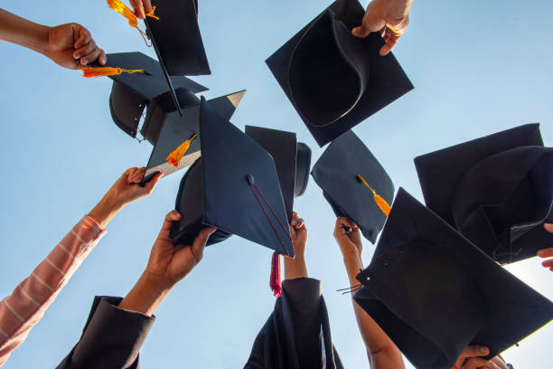 istock Black hat of the graduates floating in the sky. 1096905016