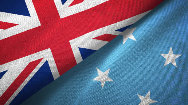 istock Micronesia and United Kingdom two flags together textile cloth, fabric texture 1096905134