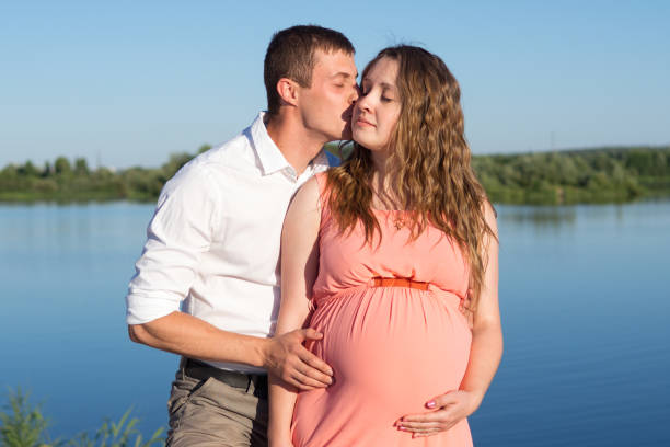 istock Young happy pregnant couple resting outdoors in summer 1096905978