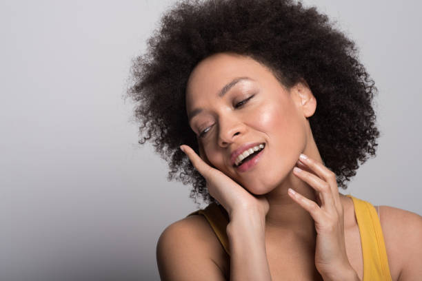 istock Smiling woman cuddling her face 1096907334