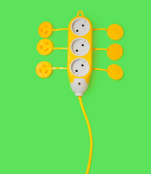 istock yellow portable socket on a green background green technology energy saving 1096908624