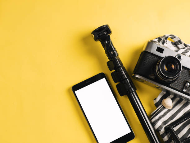 istock travel accessories top view . camera, smartphone and selfie stick with copyspace 1096913306