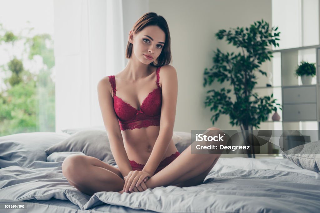 Portrait of nice cute delicate gorgeous stunning feminine lovely Portrait of nice cute delicate gorgeous stunning feminine lovely sweet attractive girlish  girl sitting on bed linen resting in modern light white interior room Women Stock Photo