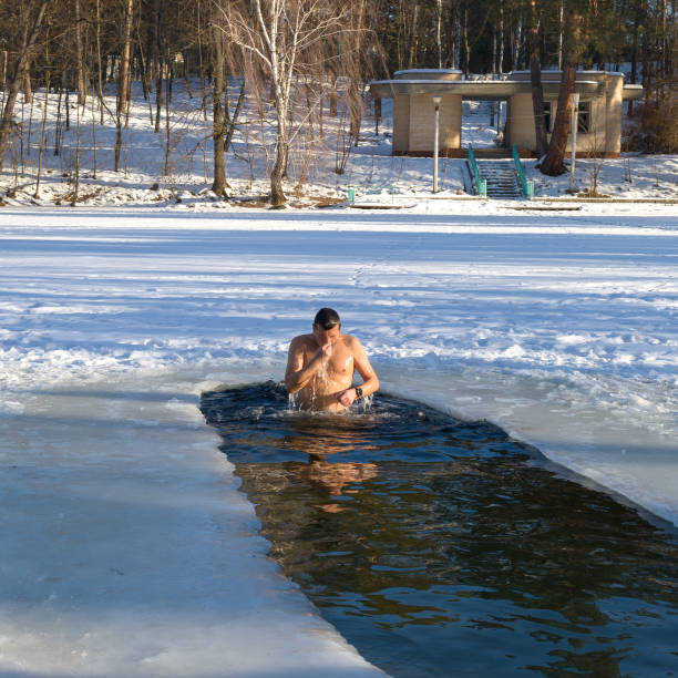istock A man is dipped into a hole in baptism 1096920260