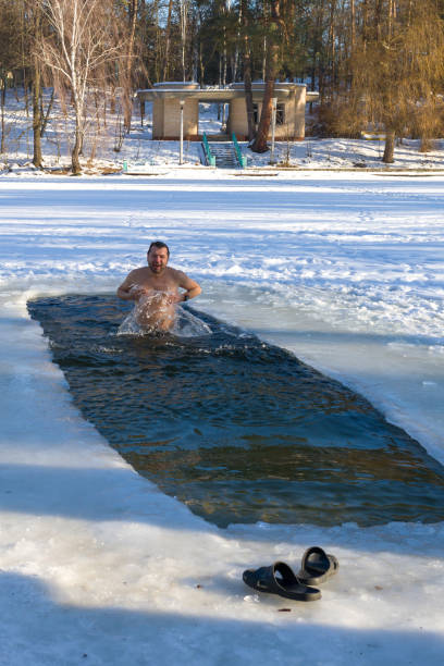 istock A man pours ice water into the ice hole. 1096920284