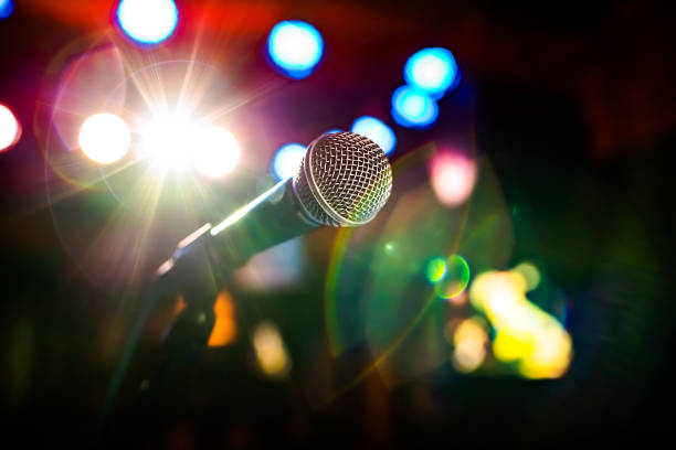 istock Microphone on stage against a background of auditorium. 1096921666