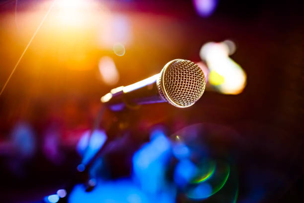 istock Microphone on stage against a background of auditorium. 1096921734