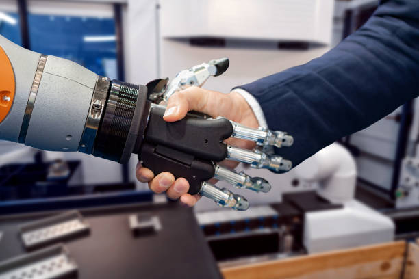 istock Hand of a businessman shaking hands with a Android robot. 1096921756
