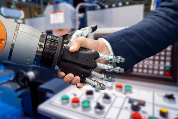 istock Hand of a businessman shaking hands with a Android robot. 1096921770