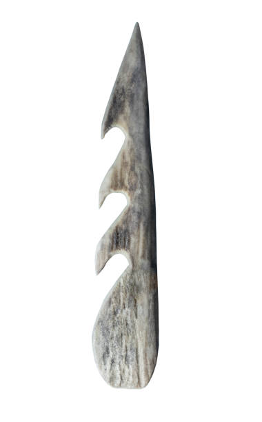 Ancient stone arrowhead on a white background, isolated