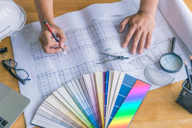 istock architect or civil engineer during drawing home or building in office on working table with office stationary , laptop ,color pallette sampling. 1096922210