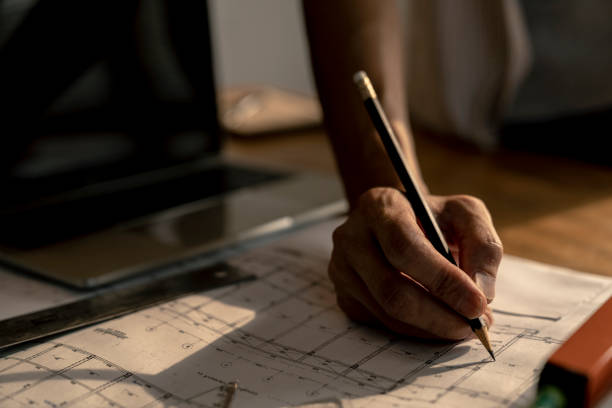 istock architect or civil engineer during drawing home or building in office on working table with office stationary , laptop ,color pallette sampling. 1096922212