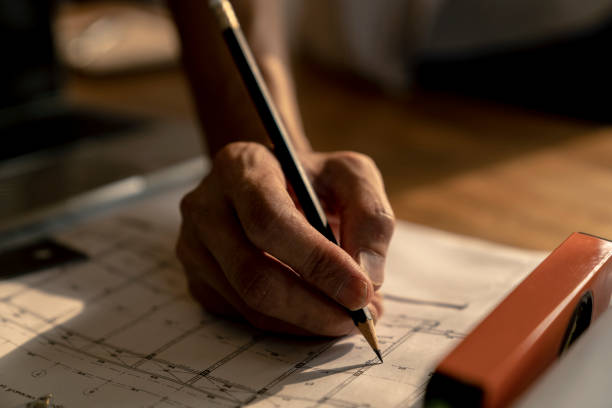 istock architect or civil engineer during drawing home or building in office on working table with office stationary , laptop ,color pallette sampling. 1096922384