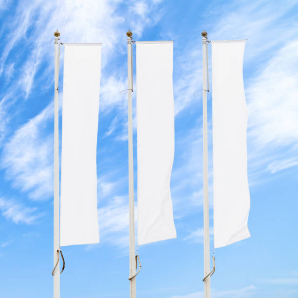 istock Three blank white corporate flags on flagpoles against cloudy blue sky 1096925466