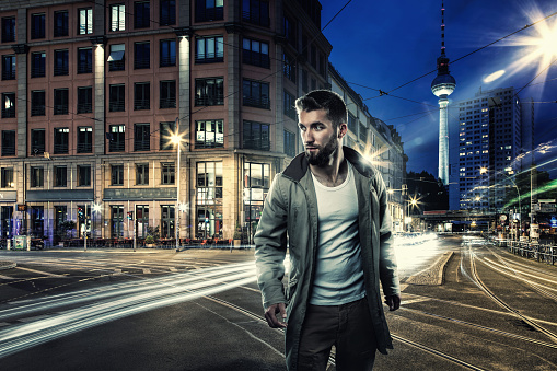 Attractive man at night on the streets of Berlin