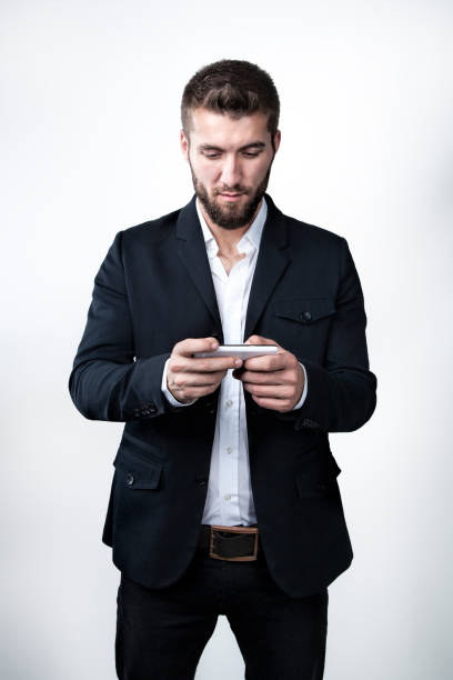 istock Attractive man with beard is playing with his smart phone 1096926090