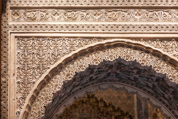 Patterns on stone arch in historical arabic style, 14th century Madraza de Granada, Spain.