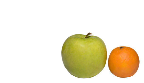 istock green apple and one orange on white background 1096928050
