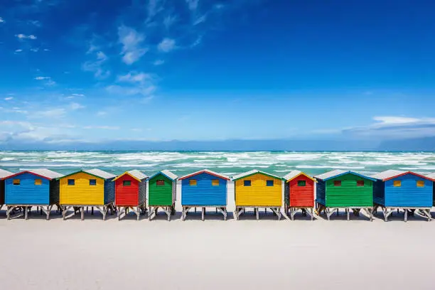 Beautiful colorful beach huts on the white sandy beach of Muizenberg, Cape Town, South Africa.