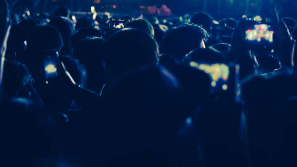 istock abstract colorful background audience in public concert. 1096931240