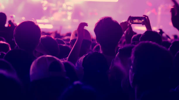 istock abstract colorful background audience in public concert. 1096931248