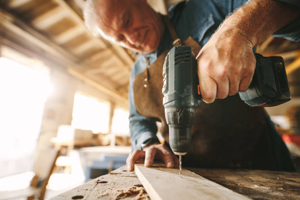 istock Drilling a hole on wooden plank 1096931436