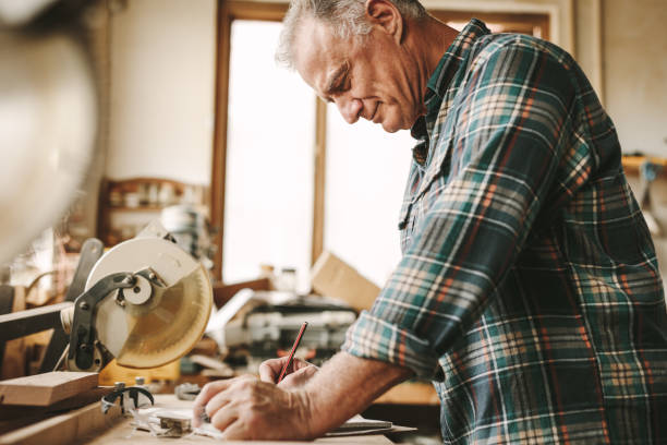 istock Senior carpenter planning his work at carpentry 1096931984