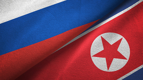 North Korea and Russia flags together textile cloth, fabric texture