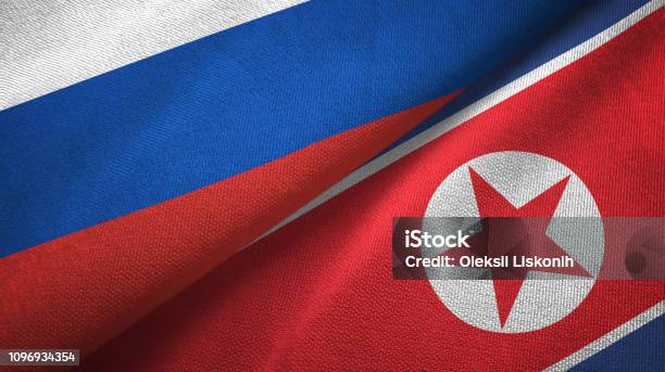 North Korea And Russia Two Flags Together Textile Cloth Fabric Texture Stock Photo - Download Image Now